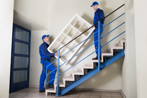 Professional removal team handling household furniture and boxes