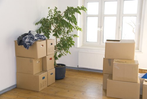 Movers carrying household items through a South Hornchurch property