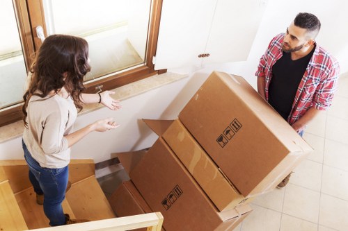 Professional movers handling furniture in a South Hornchurch property